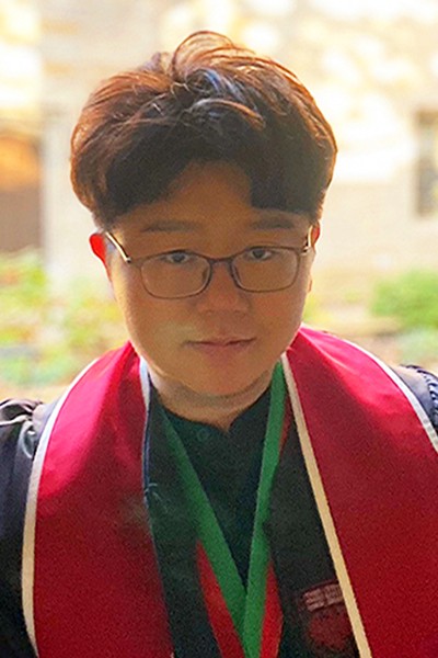 Yo Han Seol in graduation robes on the University of Chicago campus